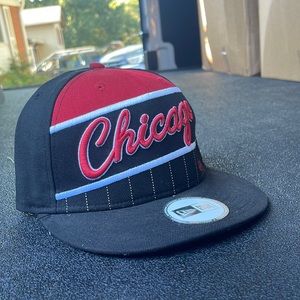 This Chicago Bulls Snapback Hat is new and unused with a green rim!